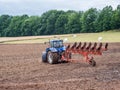 Tractor ploughs the field around