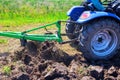Tractor ploughs a field to prepare it for sowing grain in spring Royalty Free Stock Photo