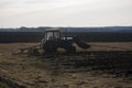 The tractor ploughs up the earth in the spring Royalty Free Stock Photo