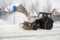 Tractor with plow, rotary mechanism clears the