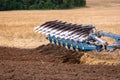 A tractor with a plow treats the soil. Royalty Free Stock Photo