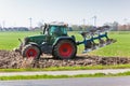 Tractor with plowes on the spring field. Royalty Free Stock Photo