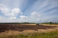 Tractor plowing farmland after harvest