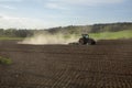 Tractor Plowing. Tractor plowing a  field and creating a cloud of dust. Royalty Free Stock Photo