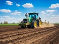 Tractor plowing field in early spring. farmer with tractor - sowing crops in agricultural field Royalty Free Stock Photo