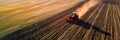 tractor plowing through fields, preparing the soil for spring planting, showcasing the mechanized side of modern