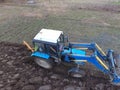 Tractor plowing the garden. Plowing the soil in the garden Royalty Free Stock Photo