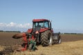 Tractor plowing at harvest time