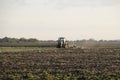 Tractor plowing plow the field. Tilling the soil in the fall after harvest. The end of the season