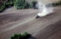 Tractor plowing a sloping field