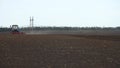 Tractor plows the farm field.