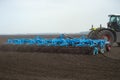 tractor preparing land with seedbed cultivator at spring farm field Royalty Free Stock Photo