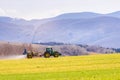 Tractor preparing spring agriculture field and using insecticide which help for the soil