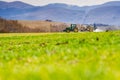 Tractor preparing spring agriculture field and using insecticide which help for the soil