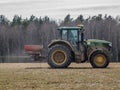 The tractor produces fertilizer for winter grain crops.