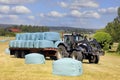 Tractor Pulling Trailer Full of Silage Bales