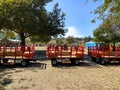 A tractor pulling a train of wagons on a seasonal adventures pumpkin patch festival.