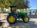 A tractor pulling a train of wagons on a seasonal adventures pumpkin patch festival.