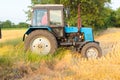 Tractor pulls up for loading to the combine with wheat