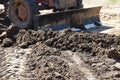 Tractor push clot soil after pour from truck