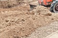 Tractor push clot soil after pour from truck