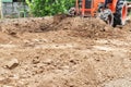 Tractor push clot soil after pour from truck