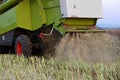 Tractor reaping the wheat spikes out of the fields Royalty Free Stock Photo