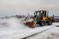 Tractor removes snow from the sidewalk