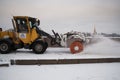 Tractor removes snow from the sidewalk