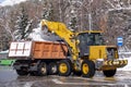 Tractor removing snow after snowfall. Winter season. Snow clearing.