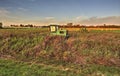 A tractor at rest, hay bales in the background Royalty Free Stock Photo