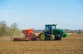 Tractor with seed drill sowing seeds in the Spring. Hertfordshire. UK