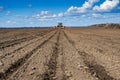 Tractor with seeder in the field in early spring Royalty Free Stock Photo