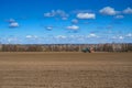 Tractor with seeder in the field in early spring Royalty Free Stock Photo