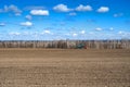 Tractor with seeder in the field in early spring Royalty Free Stock Photo