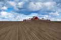 Tractor with seeder in the field in early spring Royalty Free Stock Photo