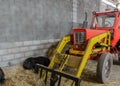 Tractor in a shed with haystacks Royalty Free Stock Photo