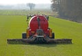 Tractor with slurry tank fertilizing meadow Royalty Free Stock Photo