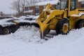 Tractor snow clearing road maintenance with heavy snowfall