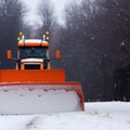 Tractor with snow plow cleaning road