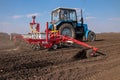 Tractor with sower on the field