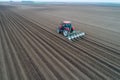 Tractor sowing field shoot from drone Royalty Free Stock Photo