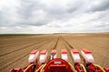 Tractor sowing of seed to field at spring time Royalty Free Stock Photo