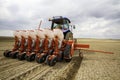 Tractor sowing of seed to field at spring time Royalty Free Stock Photo