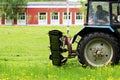 The tractor with a special nozzle automatically mows the grass on an urban lawn. Royalty Free Stock Photo