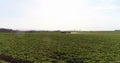 Tractor spray fertilize on field with chemicals in agriculture field. Royalty Free Stock Photo