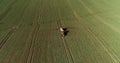 Tractor spray fertilize on field with chemicals in agriculture field. Royalty Free Stock Photo