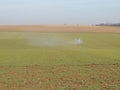 Tractor spraying chemicals in the fields