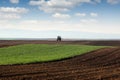 Tractor spraying field at spring agriculture rural