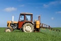 Tractor spraying green field